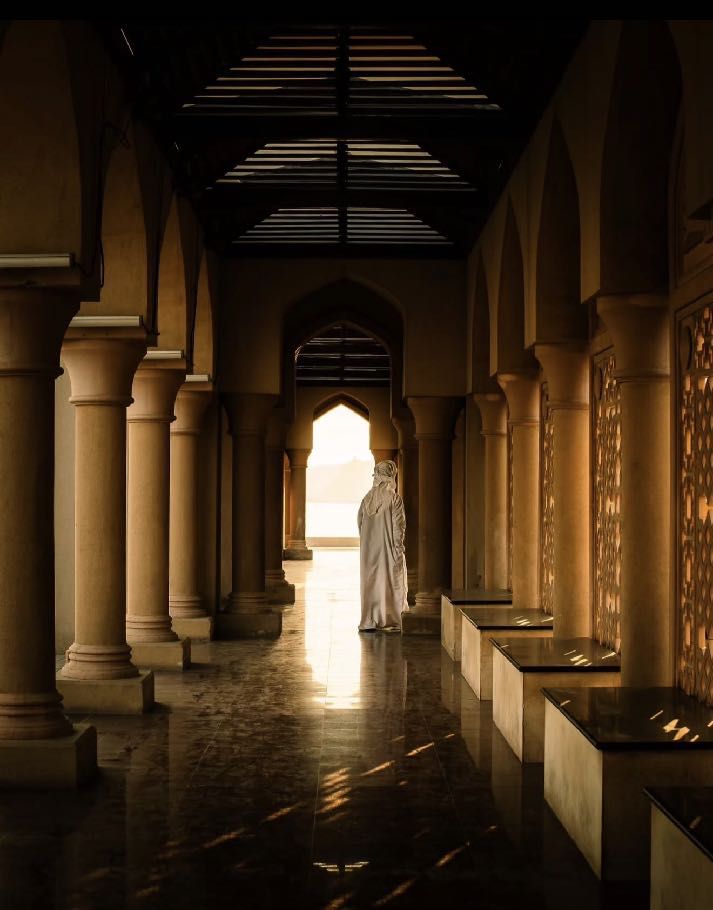 Golden light through an arched colonnade in Muscat