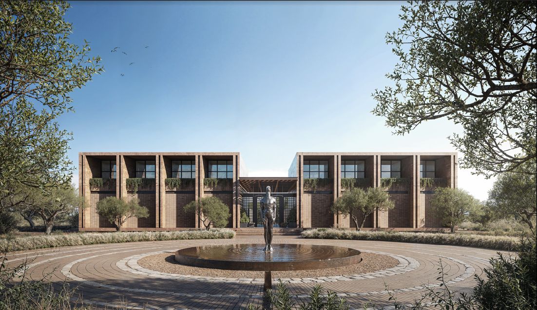The fountain court of the Spark campus, a sculpted figure standing at its center